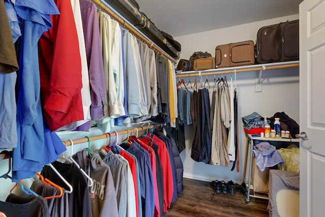 spacious closet with dark hardwood / wood-style floors