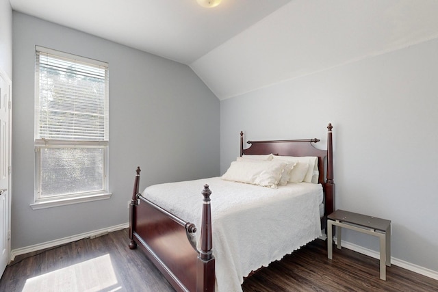 bedroom featuring lofted ceiling and dark hardwood / wood-style flooring