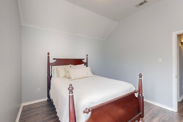 bedroom featuring lofted ceiling and dark hardwood / wood-style flooring