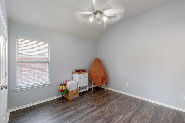 interior space with ceiling fan, lofted ceiling, and dark hardwood / wood-style flooring