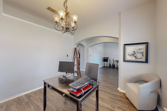 home office featuring ornamental molding, a notable chandelier, and hardwood / wood-style floors