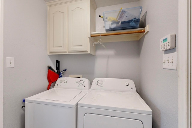 washroom featuring washer and dryer and cabinets