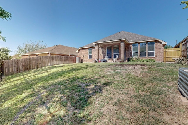 rear view of house with a yard