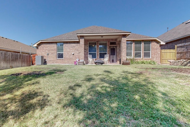 rear view of house with a yard, a patio area, and central AC unit