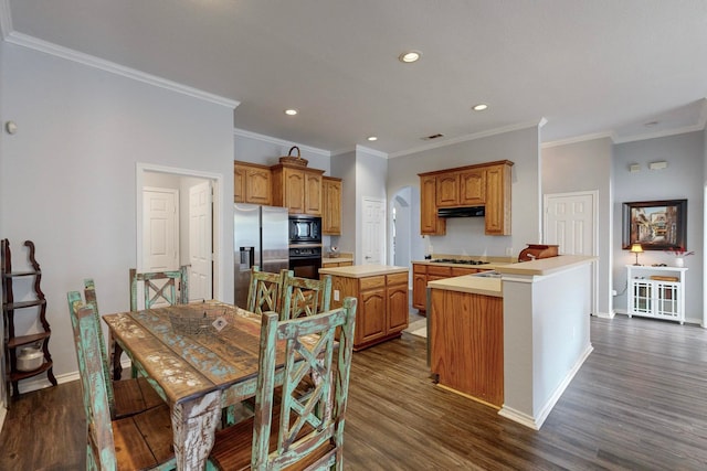 kitchen featuring dark wood-type flooring, ornamental molding, black appliances, and a center island