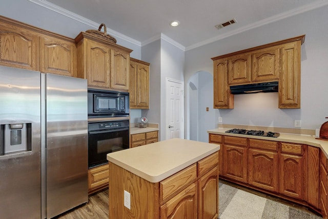 kitchen with a center island, crown molding, light hardwood / wood-style floors, and black appliances