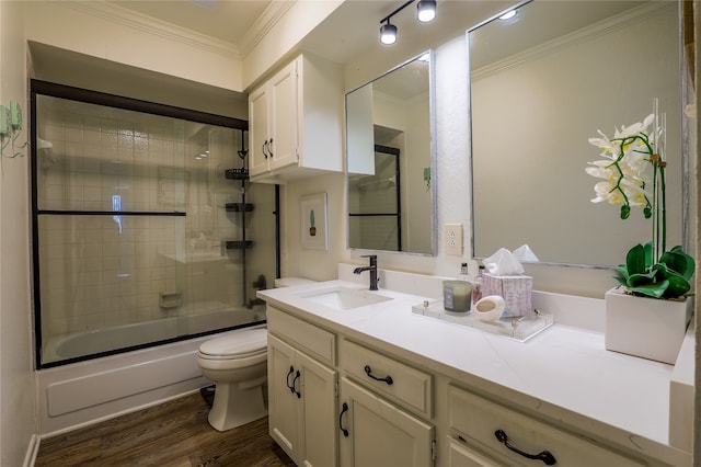 full bathroom with vanity, wood-type flooring, crown molding, shower / bath combination with glass door, and toilet