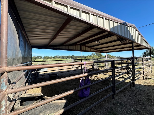 view of horse barn with a rural view