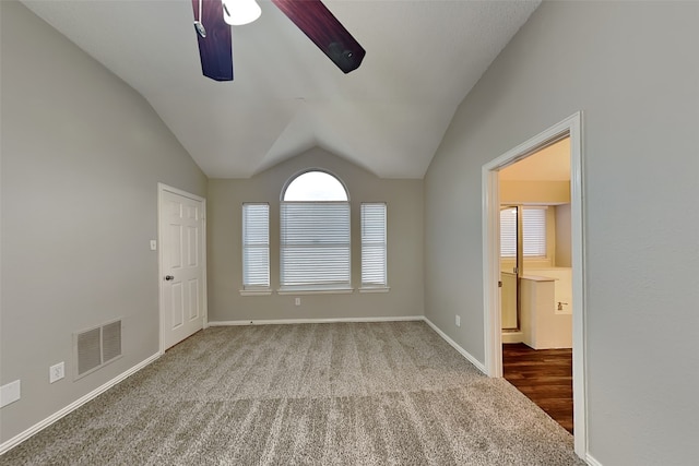 unfurnished room featuring ceiling fan, carpet, and vaulted ceiling