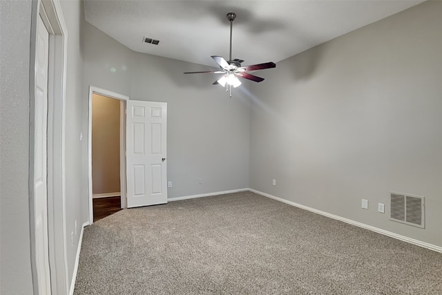 unfurnished room featuring carpet, ceiling fan, and vaulted ceiling