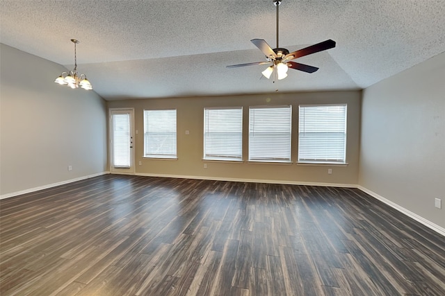 spare room with a textured ceiling, vaulted ceiling, and dark wood-type flooring