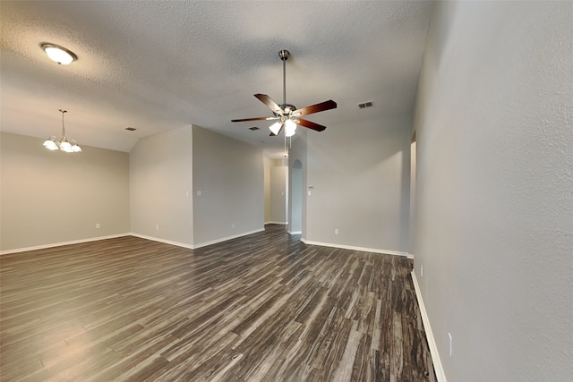 unfurnished room featuring ceiling fan with notable chandelier, a textured ceiling, dark hardwood / wood-style floors, and lofted ceiling