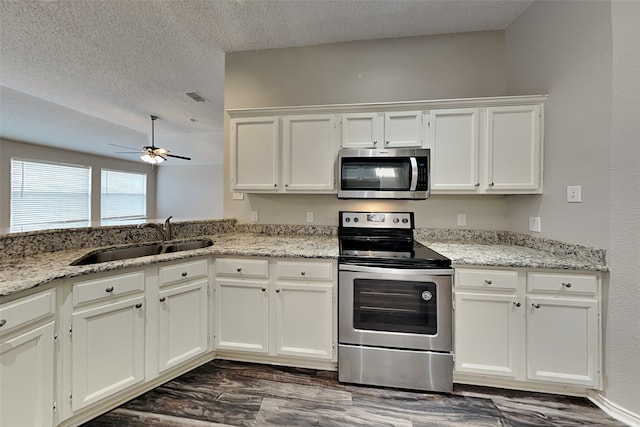 kitchen featuring ceiling fan, sink, white cabinets, and stainless steel appliances