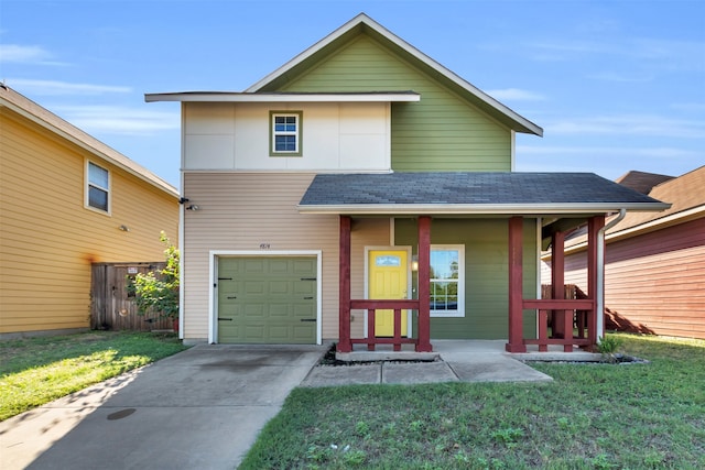 view of front of property featuring a front yard, a porch, and a garage