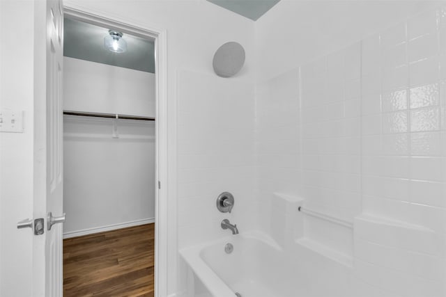 bathroom featuring wood-type flooring and shower / washtub combination