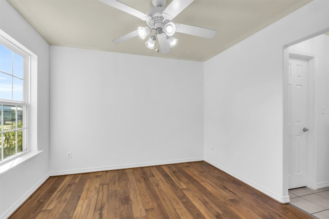 empty room featuring dark hardwood / wood-style flooring and ceiling fan