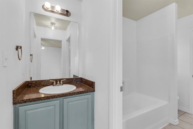 bathroom featuring vanity, bathing tub / shower combination, and tile patterned flooring