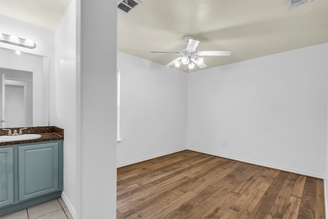 interior space with vanity, ceiling fan, and hardwood / wood-style flooring