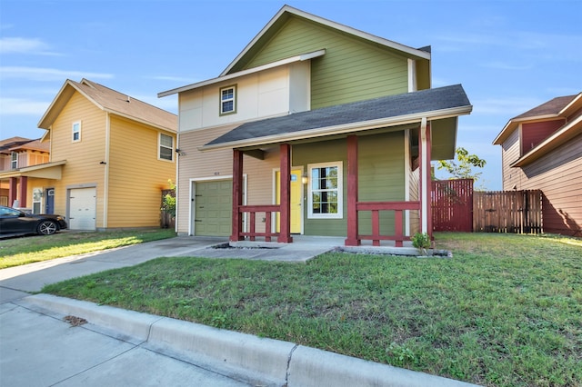 view of front of property featuring a front yard, a garage, and covered porch