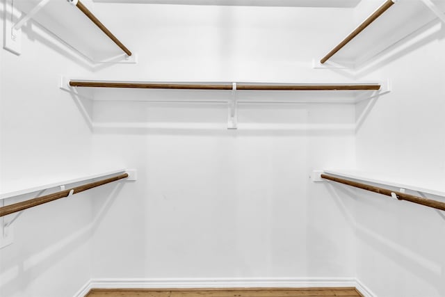 walk in closet featuring hardwood / wood-style flooring