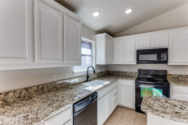 kitchen featuring vaulted ceiling, sink, black appliances, white cabinetry, and light tile patterned flooring