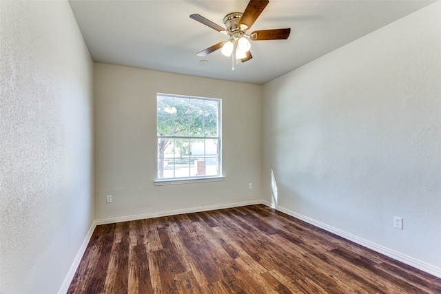 spare room with dark hardwood / wood-style floors and ceiling fan