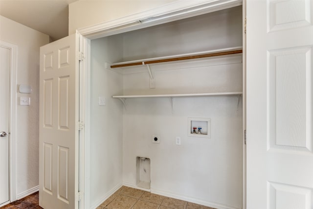 washroom with hookup for an electric dryer, hookup for a washing machine, and tile patterned flooring