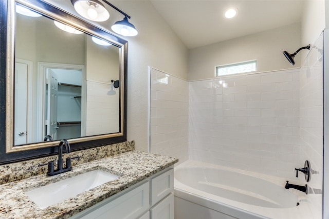 bathroom with vanity and tiled shower / bath combo