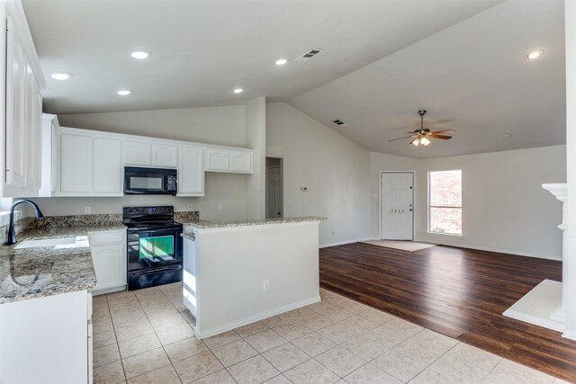 kitchen with white cabinetry, light hardwood / wood-style flooring, black appliances, and sink