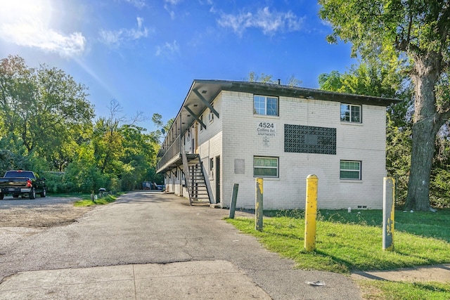 view of side of property with a lawn