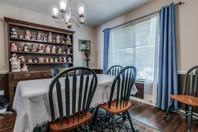 dining area with an inviting chandelier and dark wood-type flooring