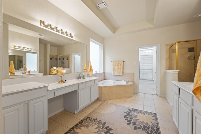 bathroom with tile patterned floors, vanity, and shower with separate bathtub