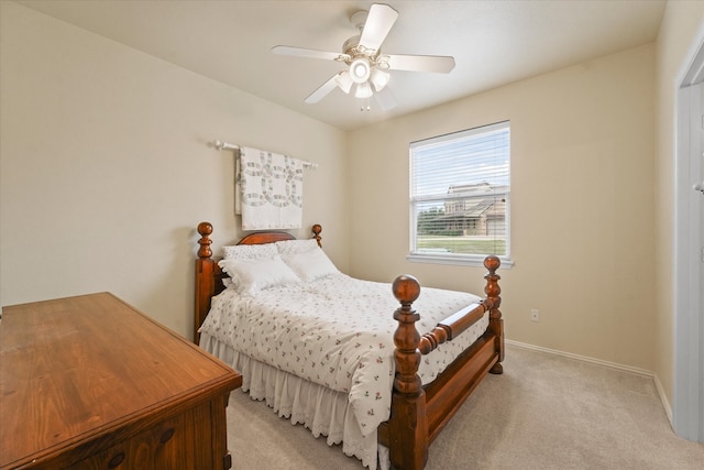 bedroom with ceiling fan and light carpet