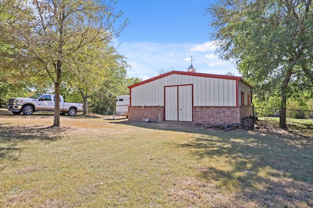 view of outdoor structure featuring a lawn