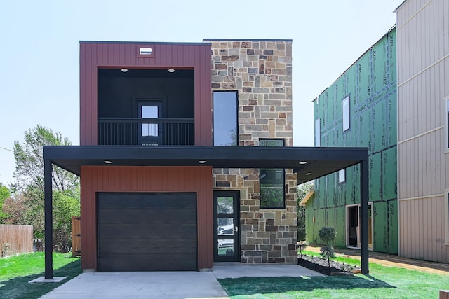 3143 Mcdermott Ave, Dallas, TX 75215 - modern home featuring stone siding, an attached garage, and concrete driveway
