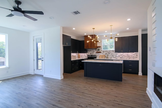 3143 Mcdermott Ave, Dallas, TX 75215 - kitchen featuring electric range, backsplash, a chandelier, plenty of natural light, and recessed lighting