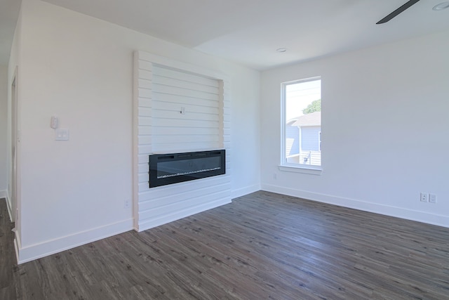 unfurnished living room with a fireplace and dark hardwood / wood-style flooring