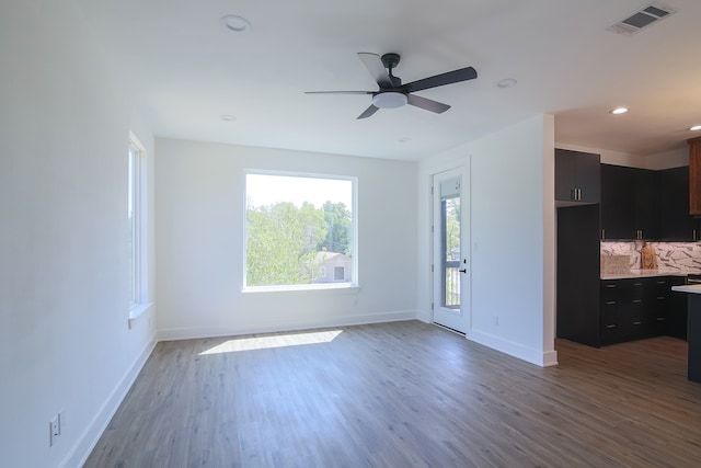 unfurnished living room featuring wood-type flooring and ceiling fan