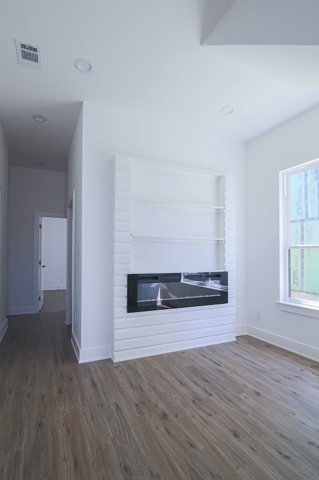 unfurnished living room featuring dark wood-type flooring