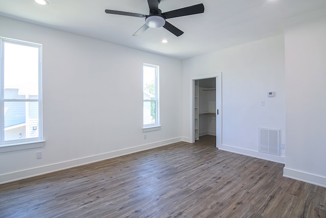 spare room featuring ceiling fan and dark hardwood / wood-style flooring