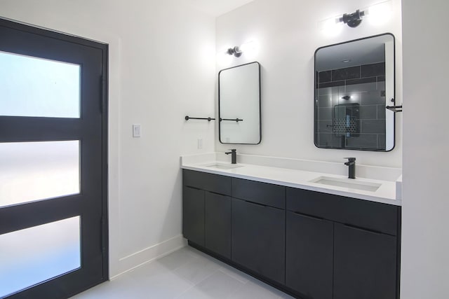 3143 Mcdermott Ave, Dallas, TX 75215 - bathroom featuring baseboards, double vanity, and tile patterned floors