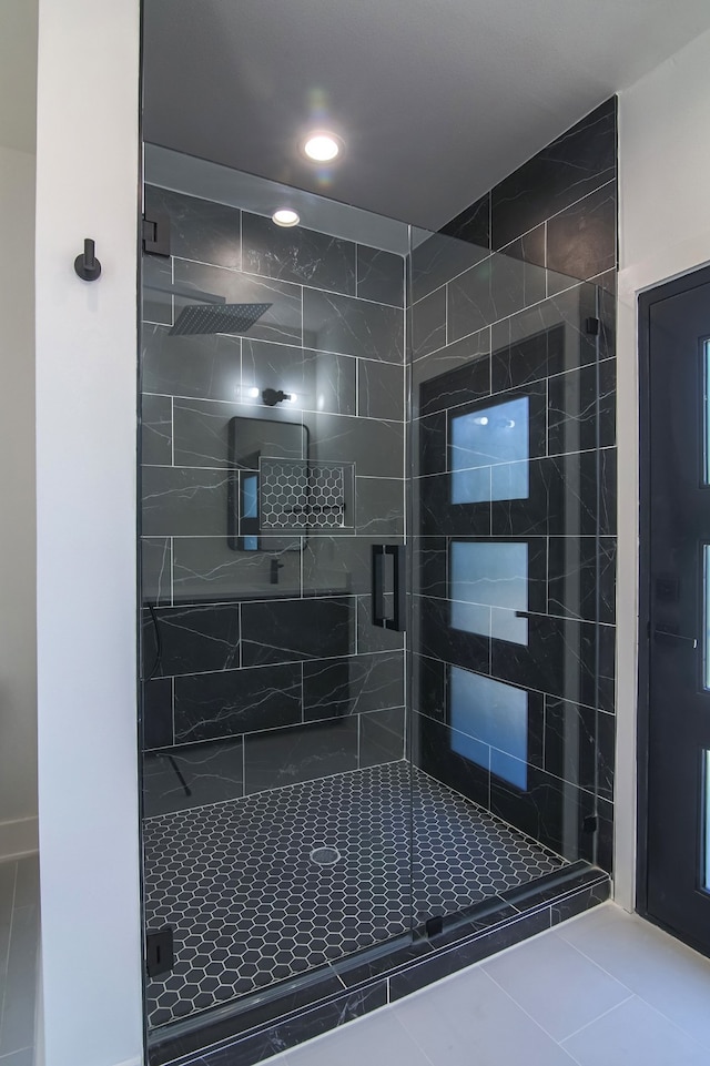 bathroom featuring tile patterned flooring and an enclosed shower