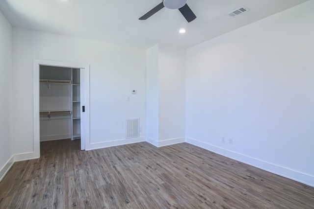 3143 Mcdermott Ave, Dallas, TX 75215 - unfurnished bedroom with wood finished floors, baseboards, a spacious closet, a closet, and recessed lighting