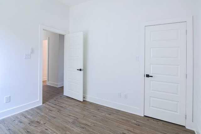 unfurnished room with wood-type flooring