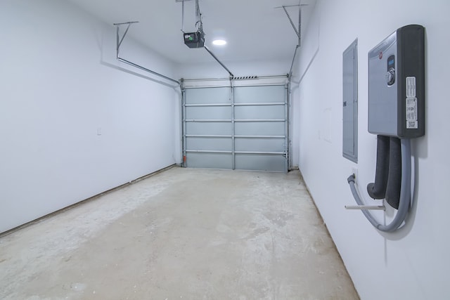 garage featuring electric panel and a garage door opener