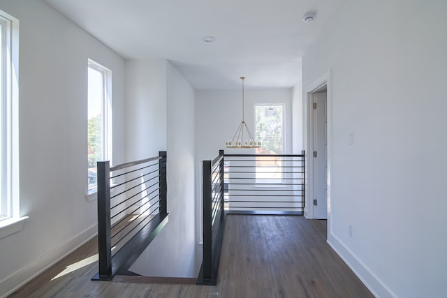 interior space with a notable chandelier and hardwood / wood-style flooring