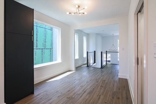 interior space with a chandelier and dark hardwood / wood-style floors