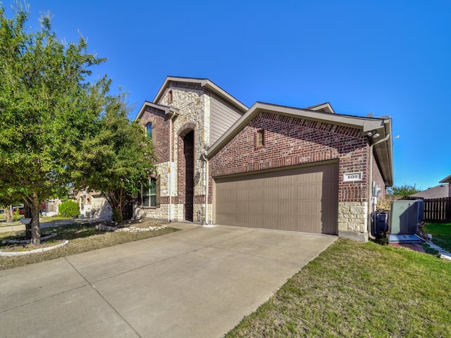 front of property featuring a front lawn and a garage