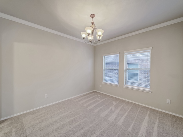 carpeted empty room featuring ornamental molding and a chandelier