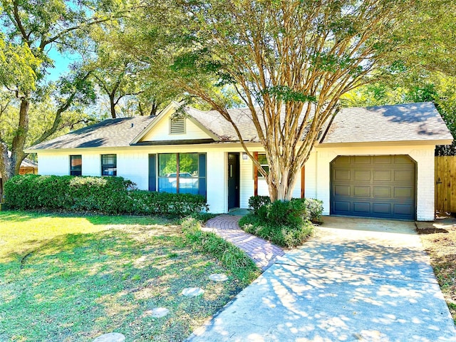 ranch-style house with a front yard and a garage